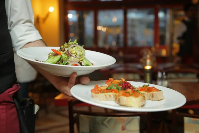 A waiter serving well-prepared dishes 