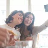 two girls taking a selfie for instagram
